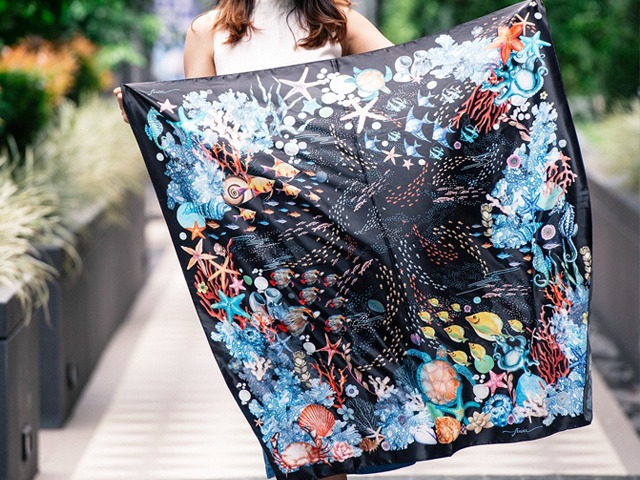 Caribbean Star scarf in black background and starfish in the center